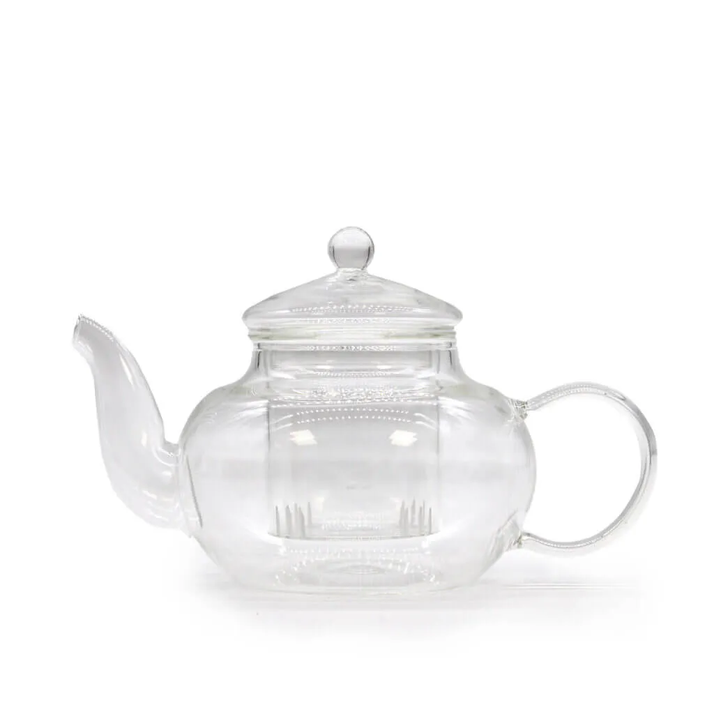 A clear glass teapot with a rounded body, a spout on the left, a curved handle on the right, and a lid with a round knob on top.