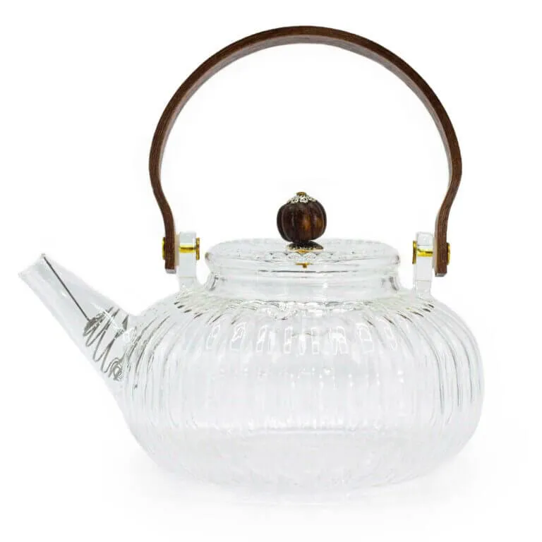 Clear glass teapot with a ribbed design, short spout, round wooden handle, and matching wooden knob on the lid.