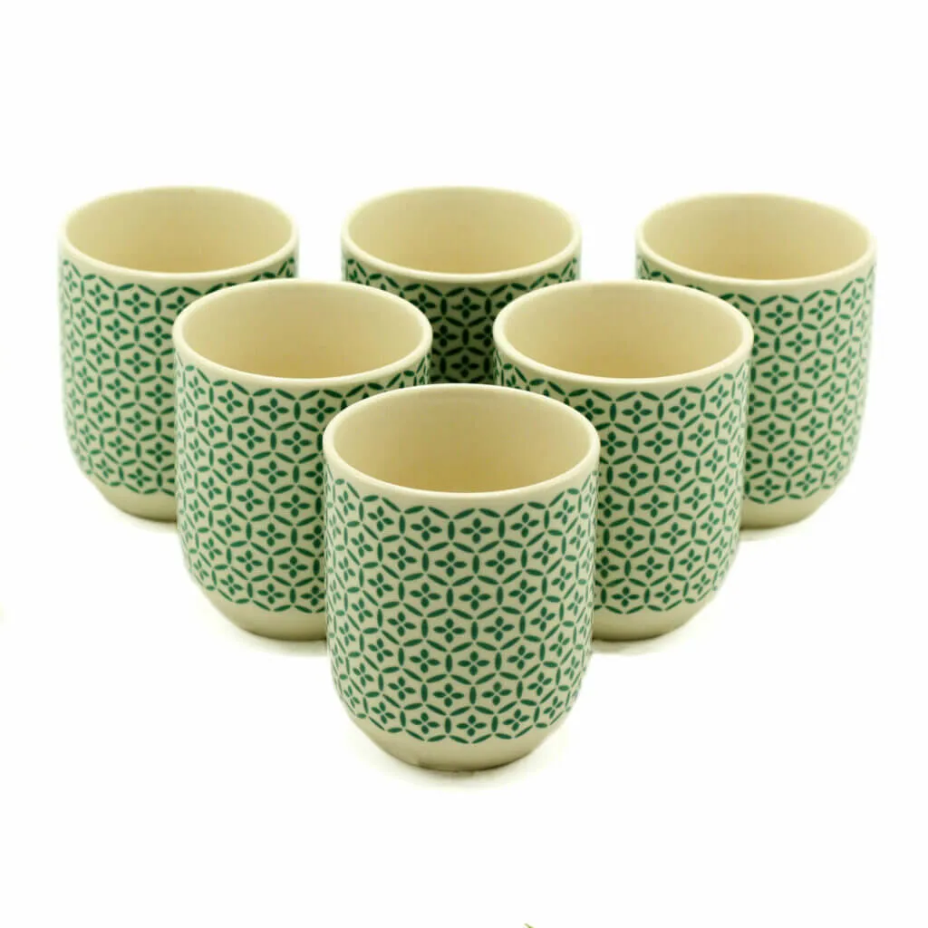 Six ceramic cups with a green geometric pattern are arranged in two rows on a white background.