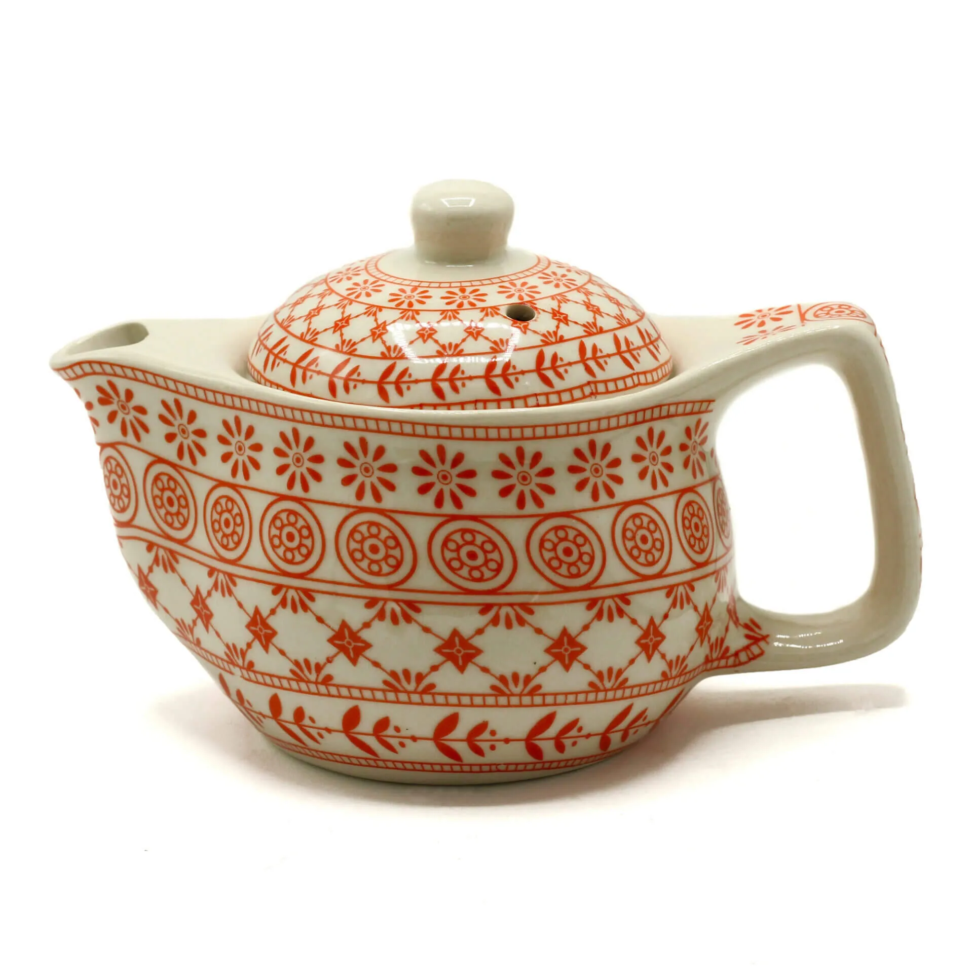 Ceramic teapot with a round lid and handle, decorated with orange geometric and floral patterns on a white background.