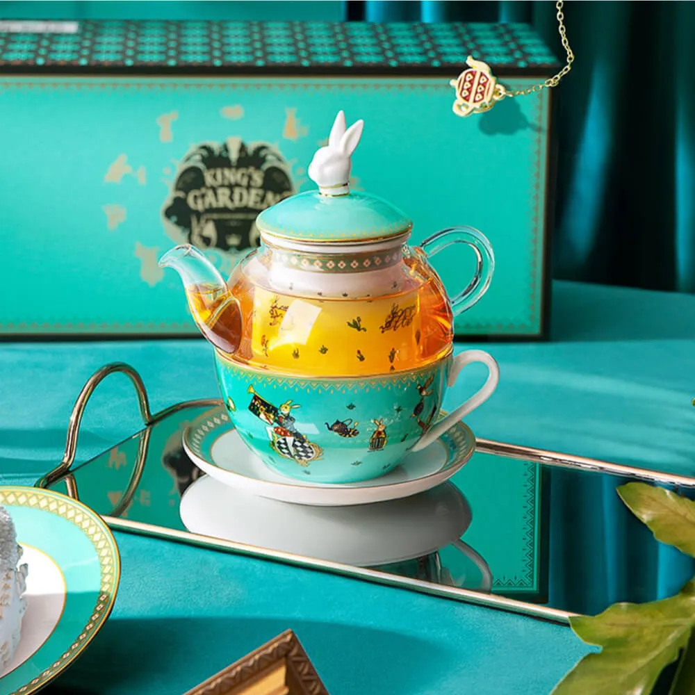 The Alice in Wonderland Inspired Rabbit Teapot Set from the Luxury Afternoon Tea Collection features a charming teal teapot with a rabbit-shaped lid, matching teacup, and a 
