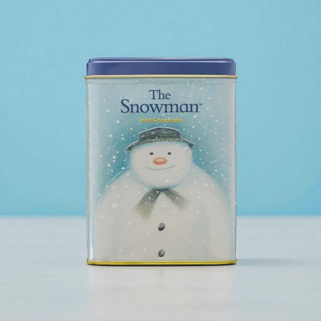A rectangular tin with a blue lid features an illustration of a snowman wearing a hat and scarf, labeled 